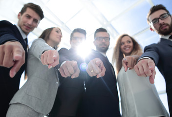 close up.successful business team pointing at you.