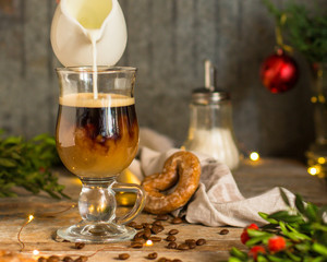 coffee in a transparent mug (with milk and spices). Top view. copy space