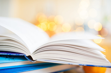 Pages of an open book on the gold bokeh background