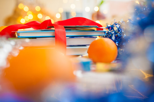 Book Gift Wrapped With Color Ribbon And Mandarin