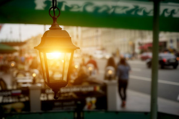 Antique garden lights with solar battery on the street cafe