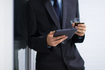 business man with tablet or computer and coffee mug