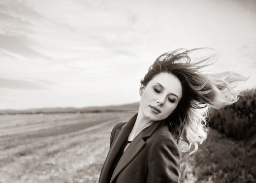 Woman Shake Head In Coat At Countryside Field . Image In Black And White Color Style