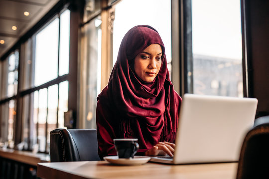 Businesswoman In Hijab Working From A Coffee Shop
