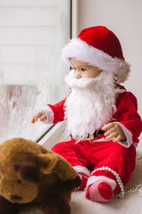 Santa Claus is waiting for Christmas. A child looks out the window waiting for Santa Claus