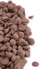 Pile of Unsweetened Carob Chips on a White Background