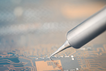 Work in progress. Soldering of electronic circuit board with electronic components. Soldering...