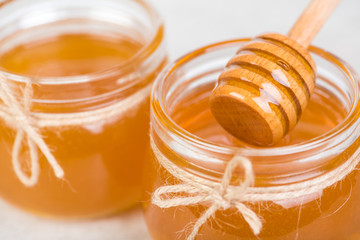 honey in jars on white table