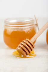 honey in jars on white table
