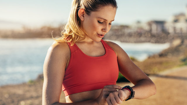 Fitness woman looking at her wrist watch