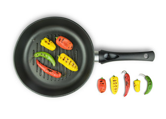 Grilled peppers fried in a pan on white