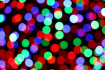 Festive Christmas background with colorful defocused bokeh lights. 