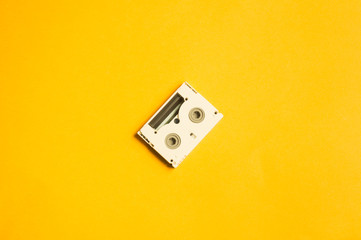 Digital video cassette on yellow background. mini cassette. copy space