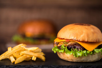 burger with french fries on wooden background