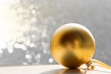 golden Christmas ball for party decoration with glitter white bokeh light background