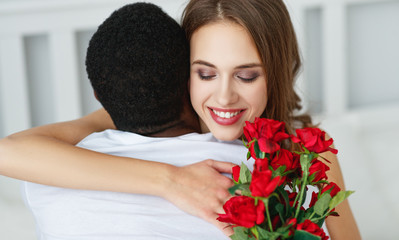 Valentine's Day. happy couple  with red hert and flowers in bed