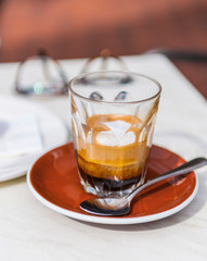 Short black coffee on table.