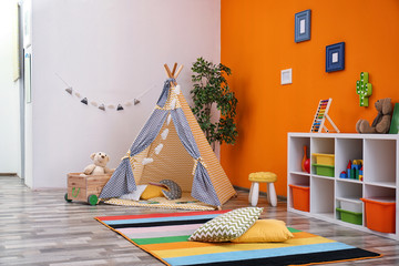Cozy kids room interior with play tent and toys © New Africa