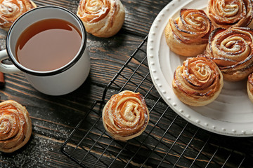 Composition with apple roses from puff pastry on wooden table