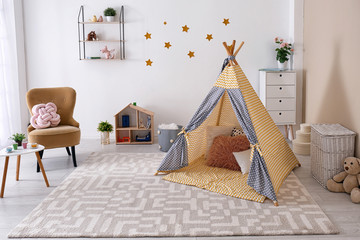 Cozy kids room interior with play tent and toys © New Africa