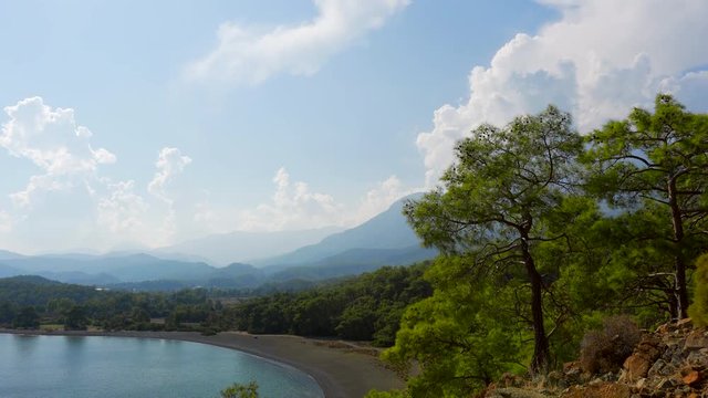 Beautiful view from the mountain to the Adriatic coast, pine forest, mountains and clouds on the background