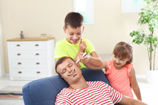 Children painting their father's face while he sleeping on April Fool's Day