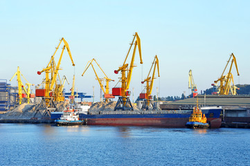 Tugboat assisting bulk cargo ship