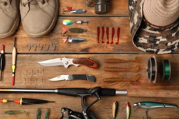Rolgordijnen Flat lay composition with fishing equipment on wooden background © New Africa