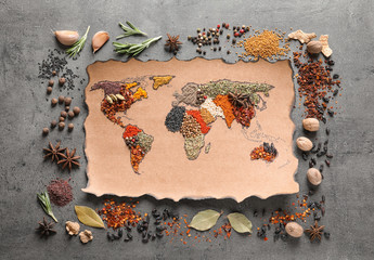 Paper with world map made of different aromatic spices on gray background, flat lay