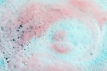 View of foam after dissolving color bath bomb in water, closeup