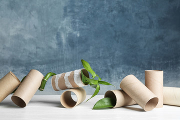 Fototapeta premium Composition with bamboo plant and empty toilet paper rolls on table. Space for text