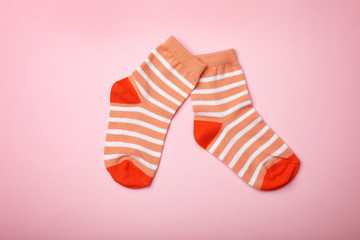 Cute child socks on color background, flat lay