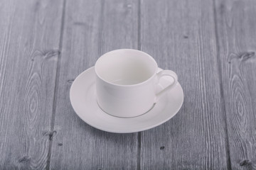 White coffee cup on wooden background.