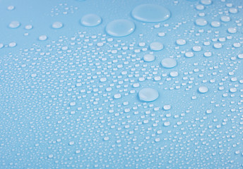 Waterdrop formation on blue background.