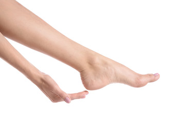 Woman touching her foot on white background, closeup. Spa treatment