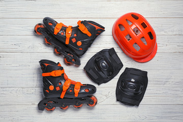 Flat lay composition with inline roller skates on wooden background
