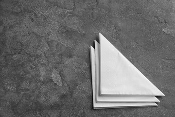 Clean napkins on grey background, top view with space for text. Personal hygiene