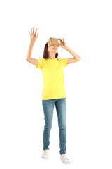 Young woman using cardboard virtual reality headset, isolated on white