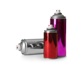 Different cans of spray paints on white background