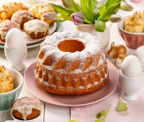 Poster Easter yeast cake sprinkled with powdered sugar on the holiday table. Traditional polish easter dessert © zi3000