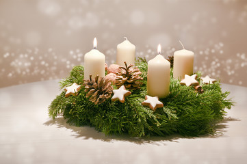 Second Advent - decorated Advent wreath from fir and evergreen branches with white burning candles,...
