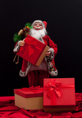 Santa Claus with gift box on black background. Christmas and new year concept.