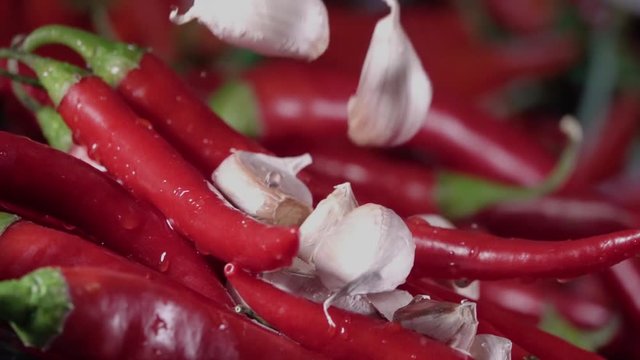 Falling of garlic into the red hot pepper. Slow motion 240 fps