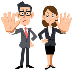 拒否のポーズをする会社員の男女
