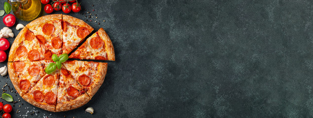 Tasty pepperoni pizza and cooking ingredients tomatoes basil on black concrete background. Top view of hot pepperoni pizza. With copy space for text. Flat lay. Banner - Powered by Adobe