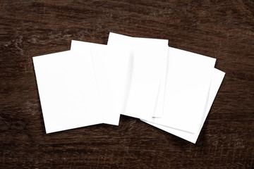 Blank portrait mock-up paper. brochure magazine isolated on brown wooden table, changeable background / white paper isolated on wood