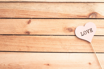 Heart on wooden background. Sunny day. Love. Holiday background