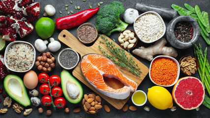 Healthy food clean eating selection: fish, fruit, nuts, vegetable, seeds, superfood, cereals, leaf...