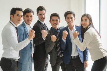 Group of cheerful business people showing confidence in coworkers.