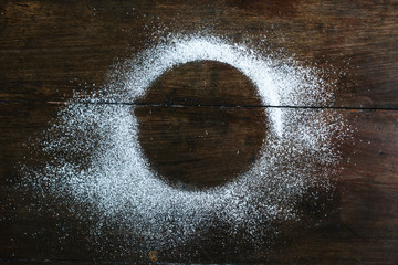 Round shaped flour scattered on a wooden table
